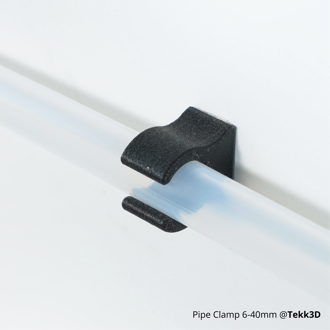 Black ABS-GF clamp securing a pipe